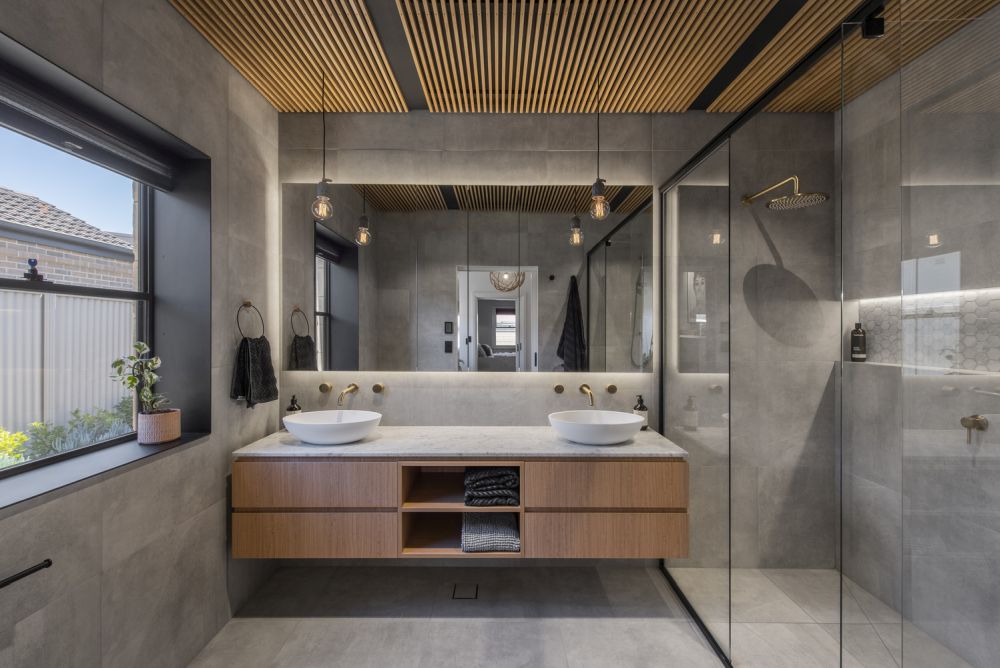 Большое настенное зеркало и минималистичная стеклянная душевая кабина придают этой ванной комнате очень открытый и воздушный вид.